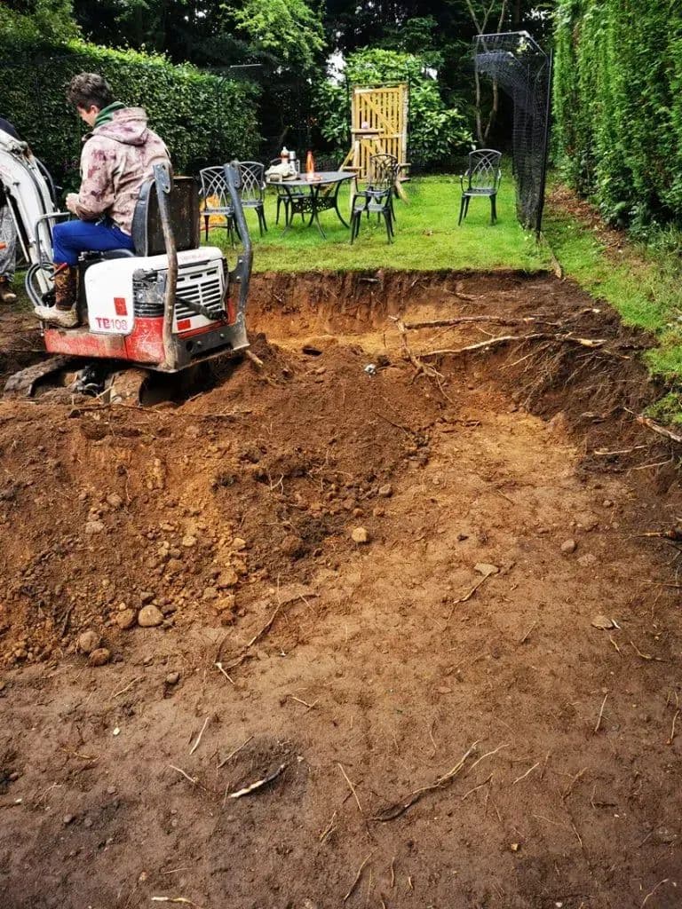 The digger working out the bank of earth where the gazebo was to stand