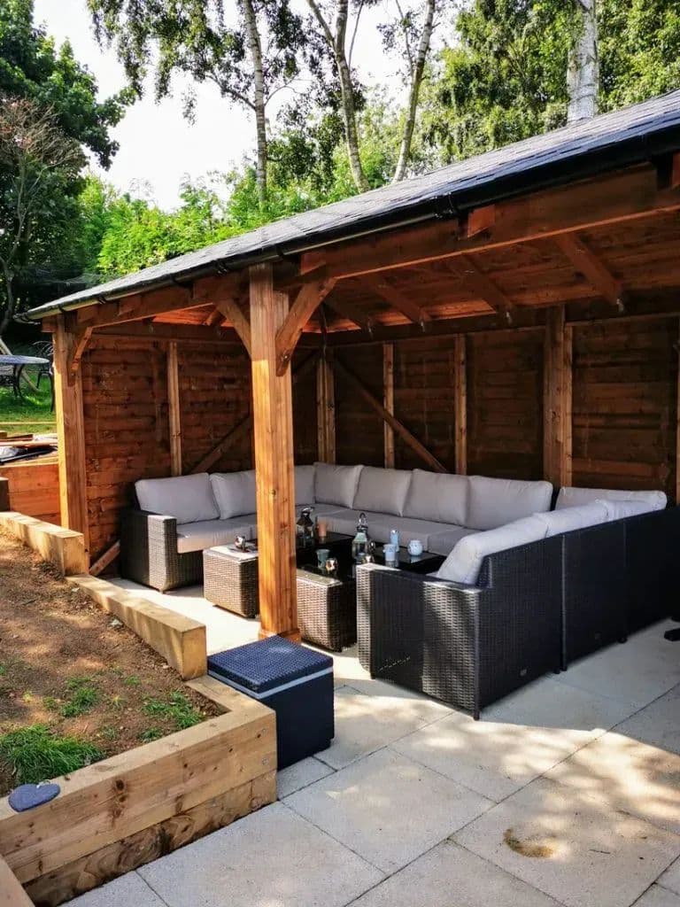 The gazebo from the side, with a timber sleeper bed running along the paving in front of it