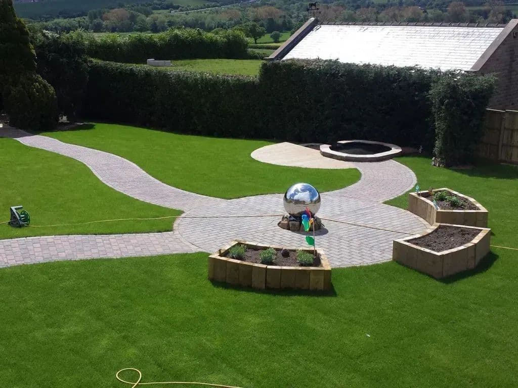 The centre point where the paths meet, with a mirrored sphere and sleeper planters around it
