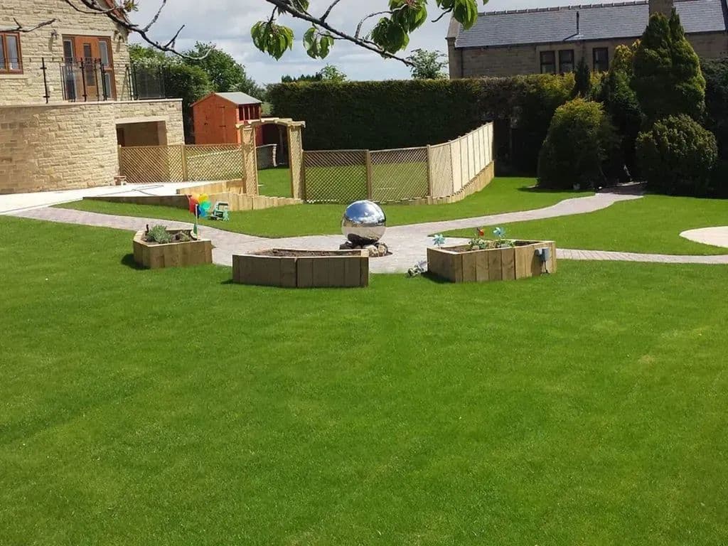 Paths branching out from the centre of the garden across the new lawn, with sleeper beds either side
