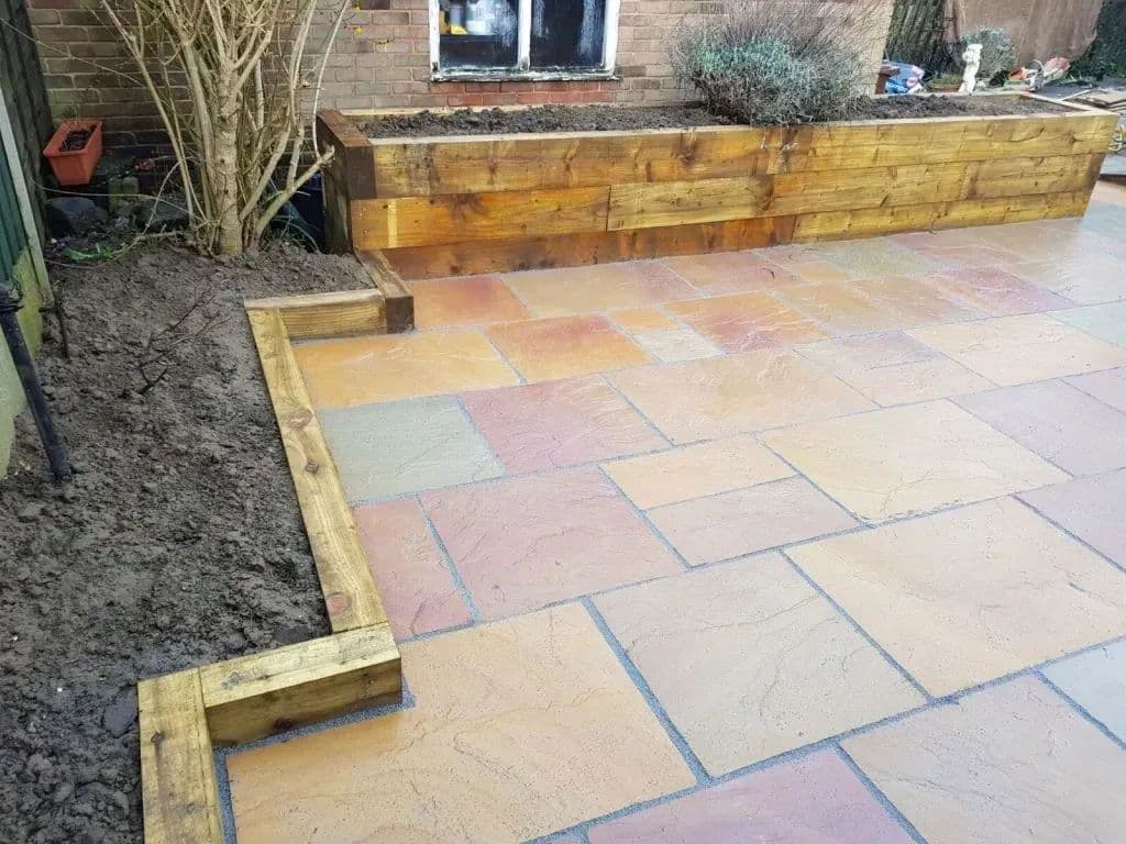 The corner of the sleeper planter where it turns and steps down to the paving