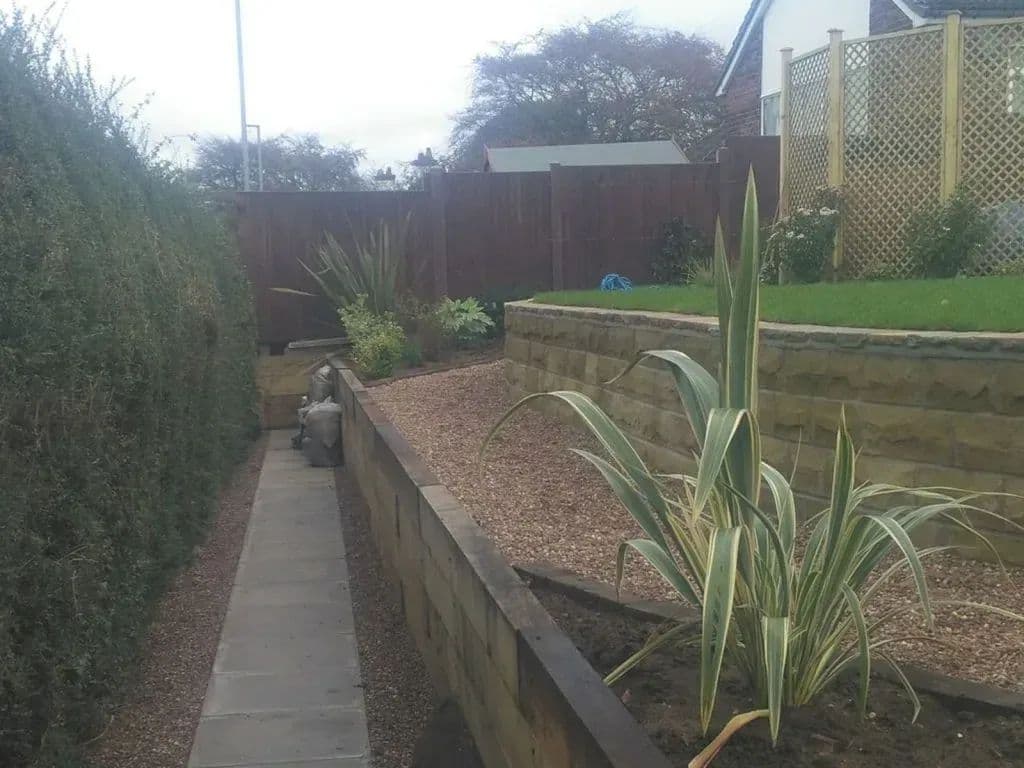 The path running along the hedge line with a raised timber bed beside it