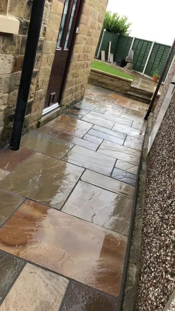 Indian paving stones laid up to the back door with a gravel strip alongside