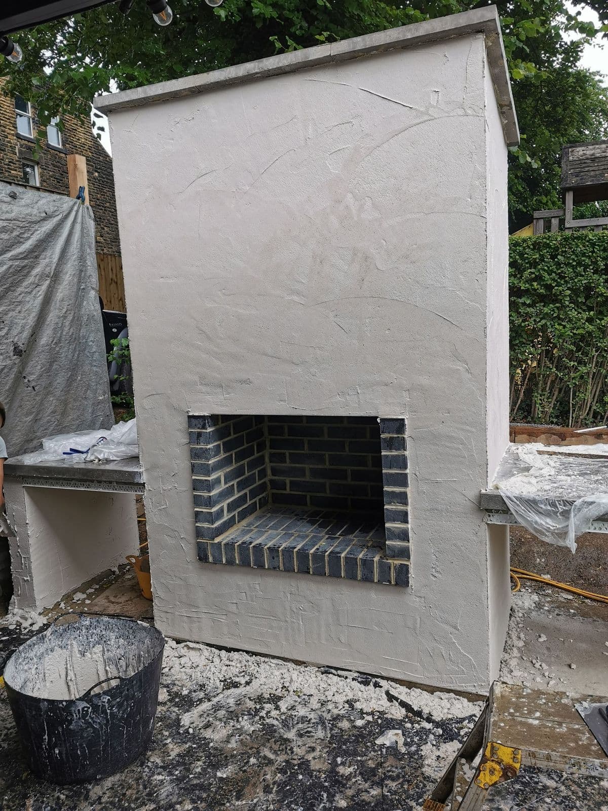 Close on the Staffordshire blue brick oven opening, with chrome beading at the edges of the render
