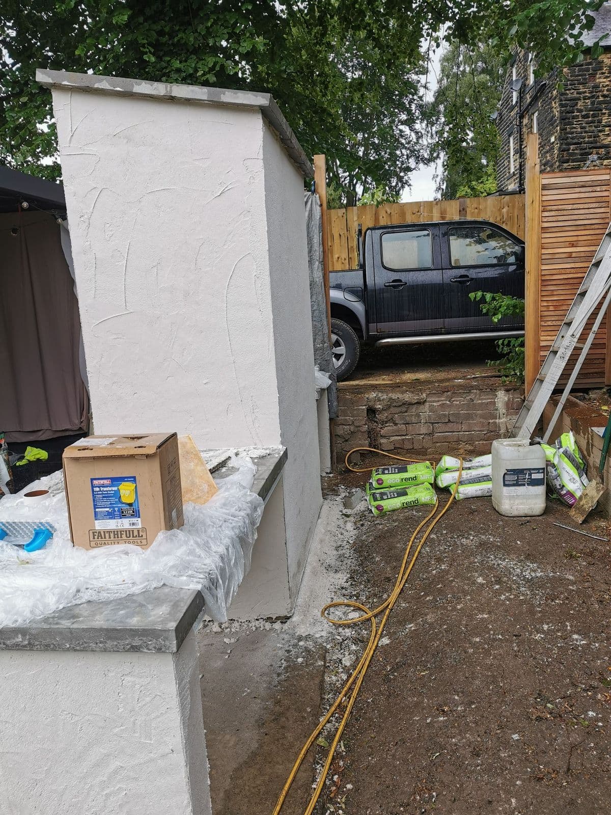 The oven from the side, with the rendered flue running up above the polished concrete counter