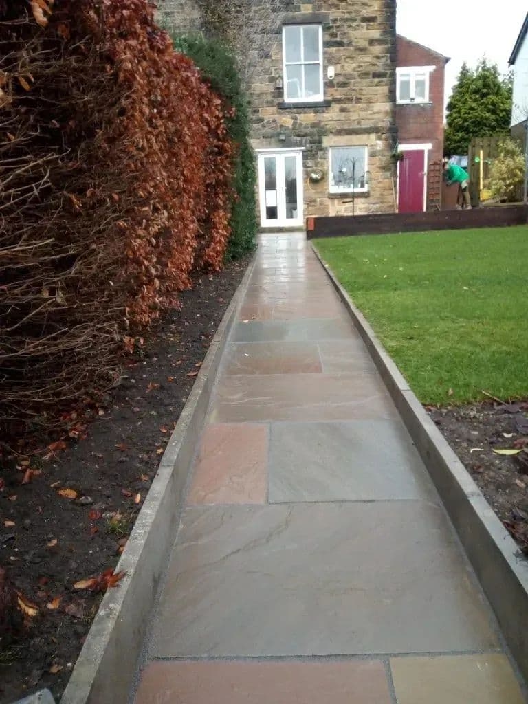 The path running beside the beech hedge towards the nursery doors
