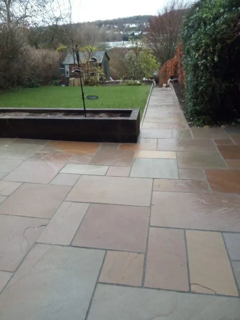 The paving looking back along the raised bed towards the lawn and the path