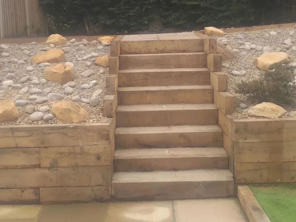 Oak sleeper steps running up through the rockery to the top of the garden
