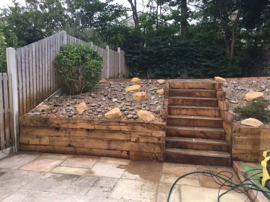 Oak sleepers terracing the slope with new timber steps running up through them