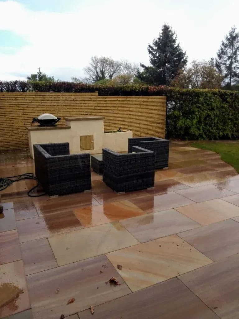 The built-in barbecue and rendered herb planter at the edge of the patio