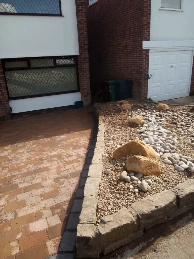 The block paving meeting the cobble bed at the corner of the house