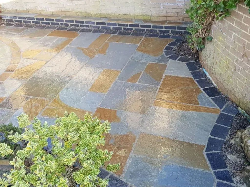 Old York paving with its midnight blue sett edging curving round the border