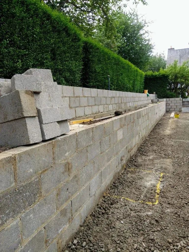 The blockwork retaining wall built along the length of the garden