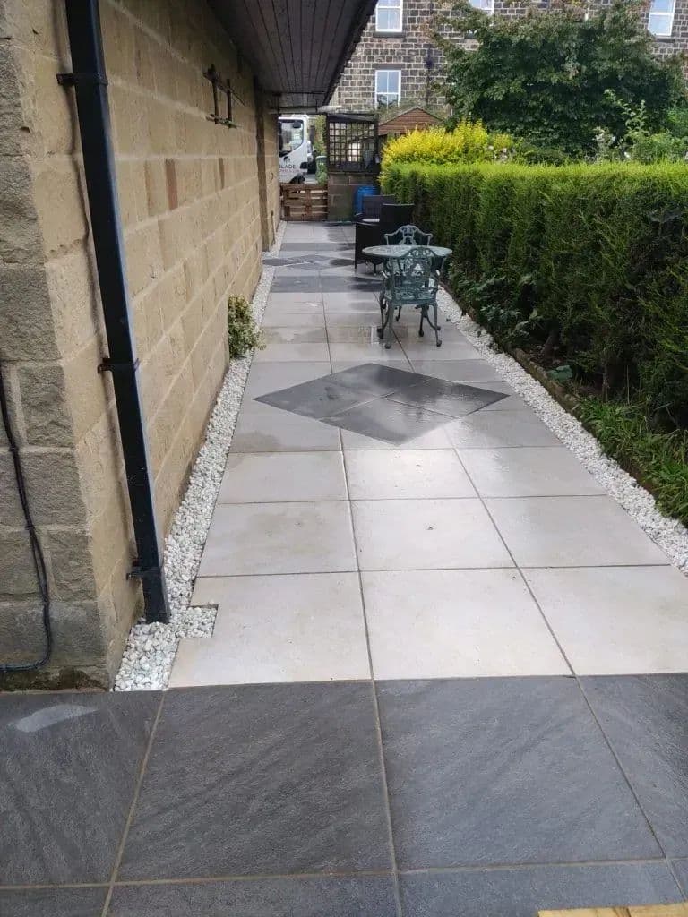 The paved path running along the house, with slate flags set into the porcelain