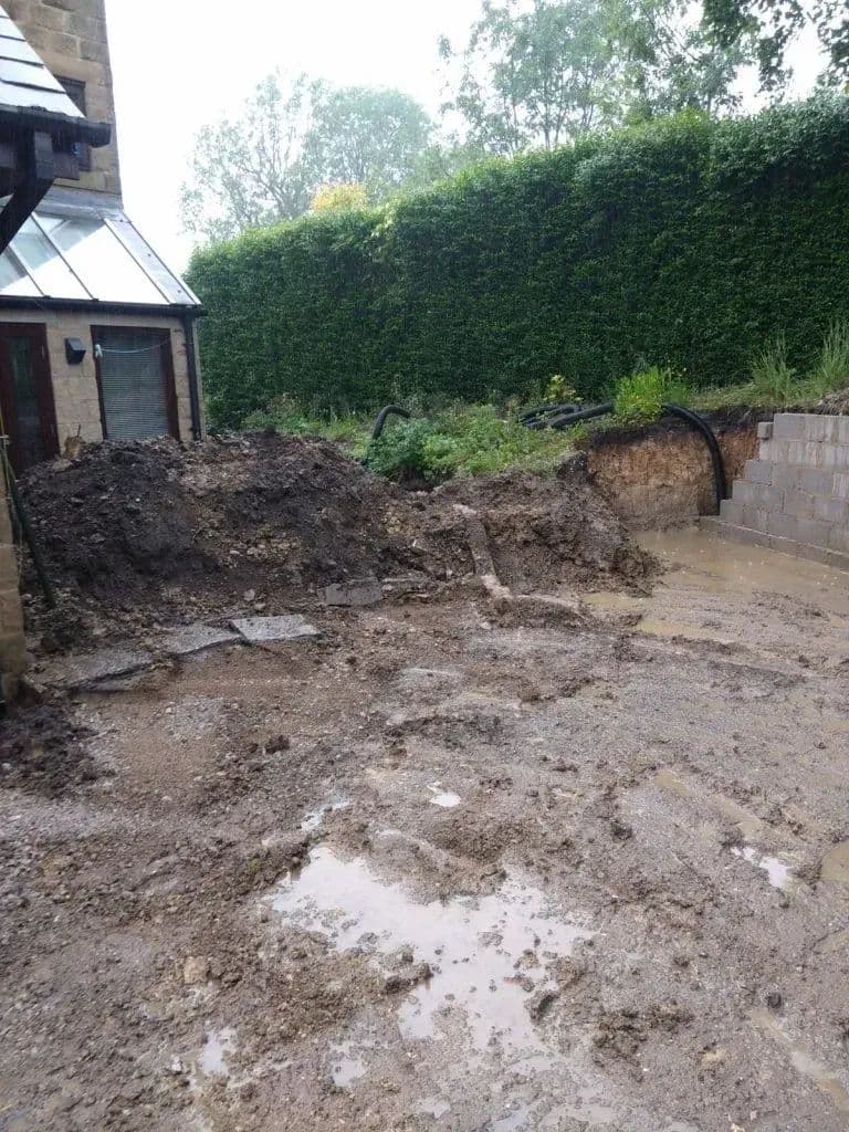 The garden stripped back to bare ground with the spoil banked up