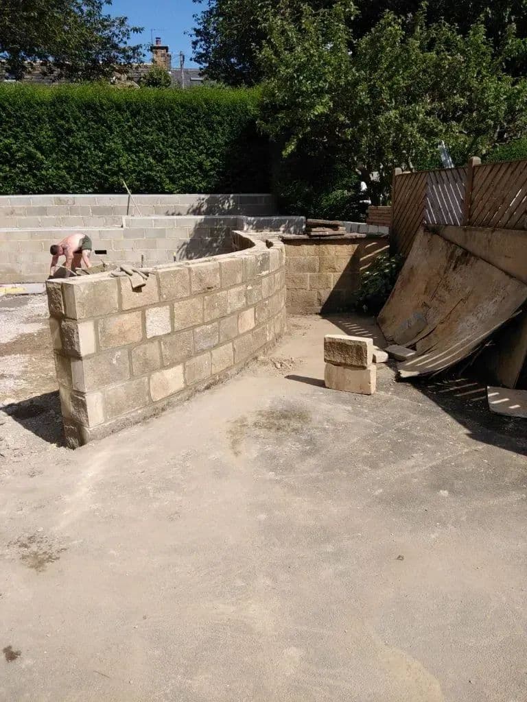 The walls finished and the ground levelled, ready for the paving to go down